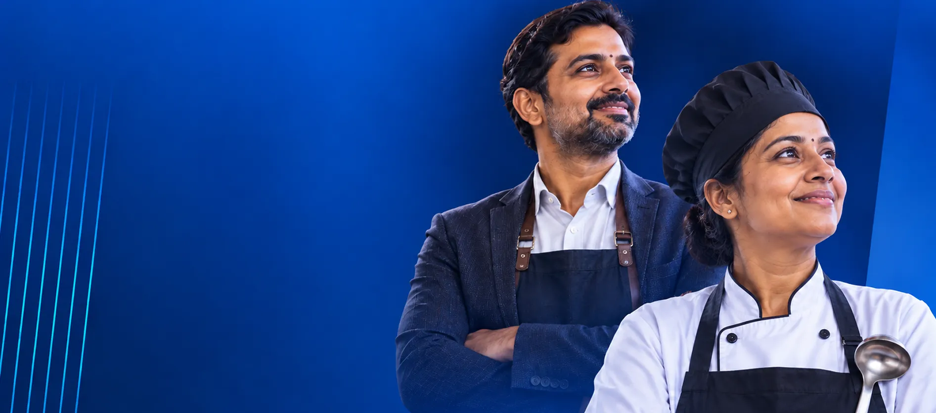 Restaurant manager and chef smiling and looking ahead against a blue background