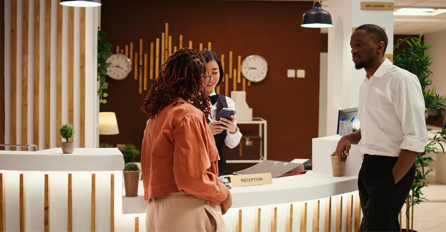 Guests being welcomed at a hotel reception desk