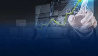 Businessman pointing at a glowing digital interface with an upward green arrow chart