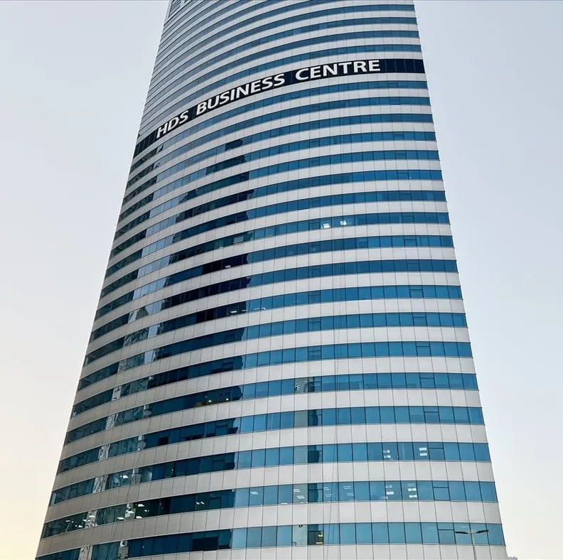 HDS Business Centre, a curved blue-glass office tower in Dubai