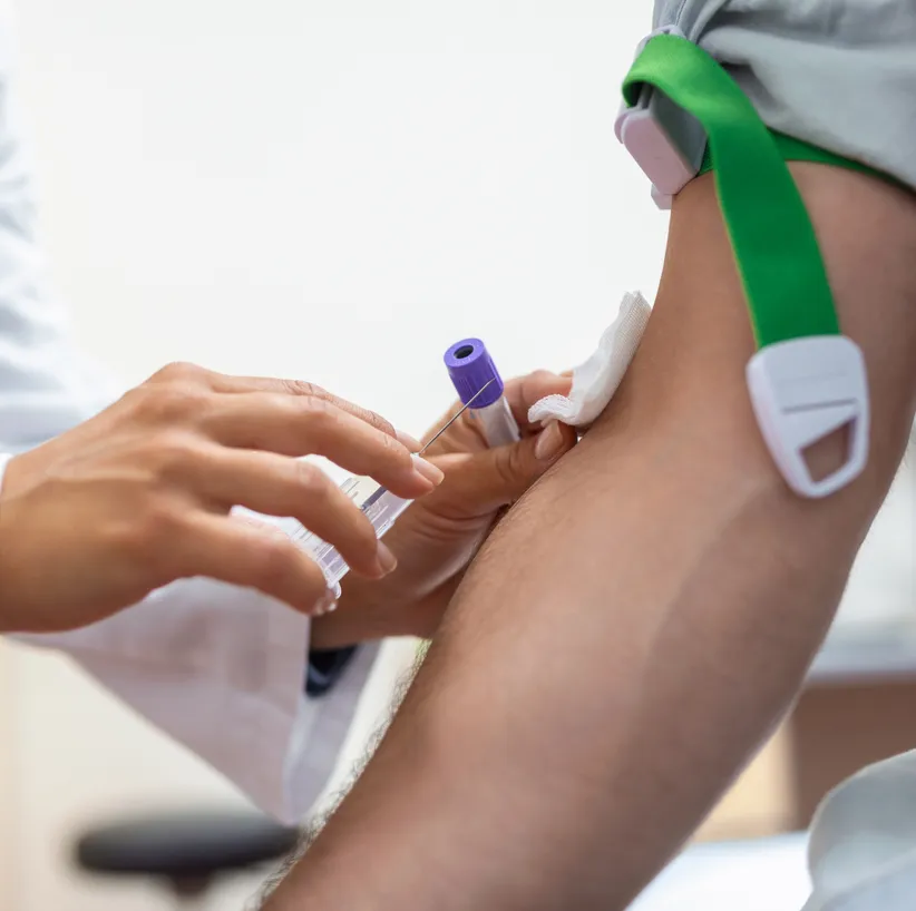 Doctor drawing a blood sample from a patient’s arm