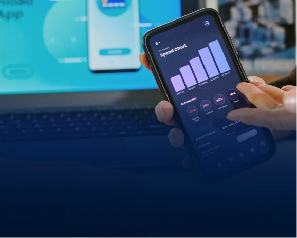Hand holding a smartphone showing a spend chart and breakdown pie chart