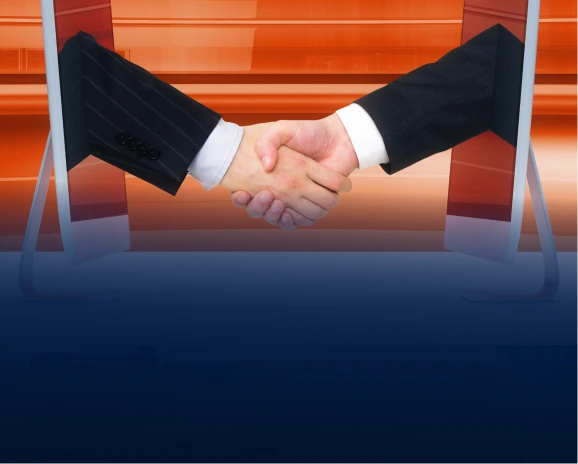 Two suited arms reaching from screens to shake hands symbolising online conversion